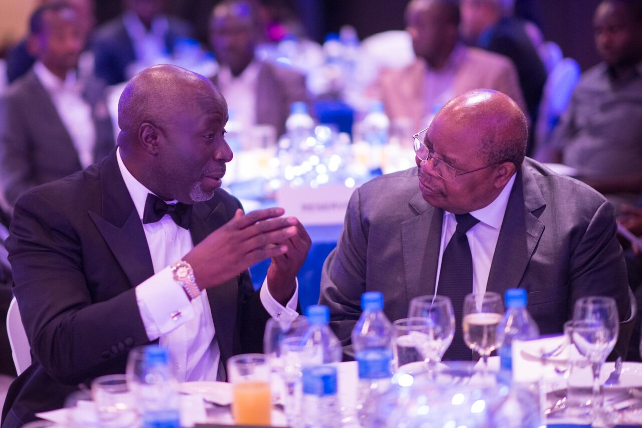 A CEOrt member in conversation with the late President Benjamin Mkapa at a dinner