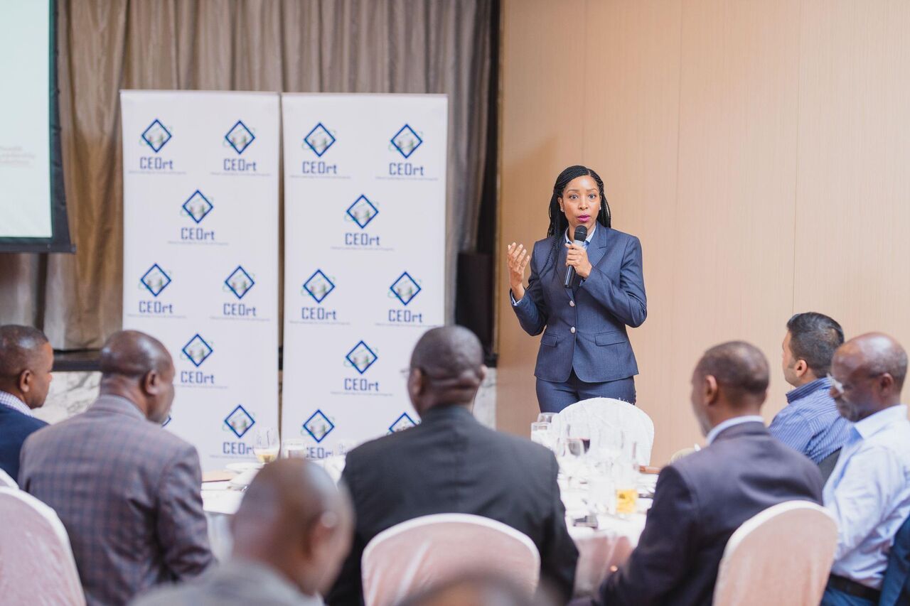 A speaker presenting to members against a CEOrt backdrop